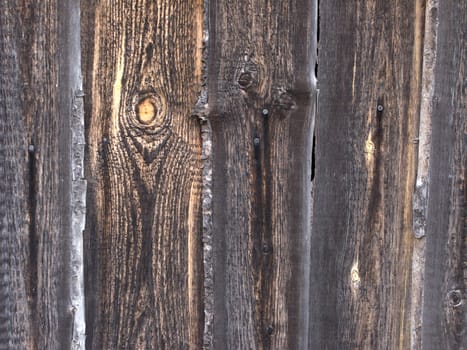 Fragment of weathered dark rough wooden wall