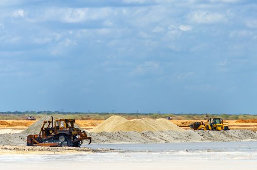 Heavy machinery gathering salt in Manaure in La Guajira, Colombia