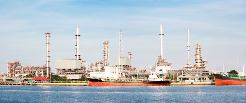 panorama landscape of Oil refinery plant along river with tanker