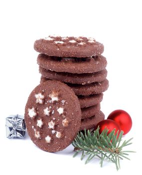 Stack of Christmas Chocolate Chip Cookies with Sugar Powder Shape Stars,  Green Spruce Branch, Red Bauble and Silver Gift Box isolated on white background
