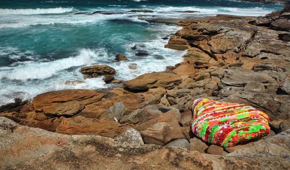 Bondi - Tamarama, Australia - October 29,  2013: Sculpture By The Sea, 2013. Annual cultural event that showcases artists from around the world  Exhibit titled 'Polyrock ' by Bev Goodwin (New Zealand).  Medium -  polynesian leis, foam rings, wire, cable ties