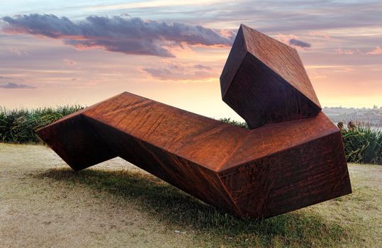 Bondi, Australia - November 9,  2013: Sculpture By The Sea, Bondi 2013. Annual cultural event that showcases artists from around the world  Sculpture titled Encounter' by Jorg Plickat (Germany).  Medium - corten steel.  Price $35000