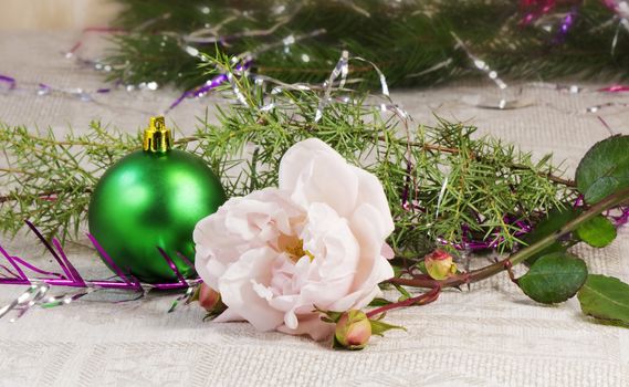 Beautiful shiny green ball , rose and branches of a Christmas tree ornament.