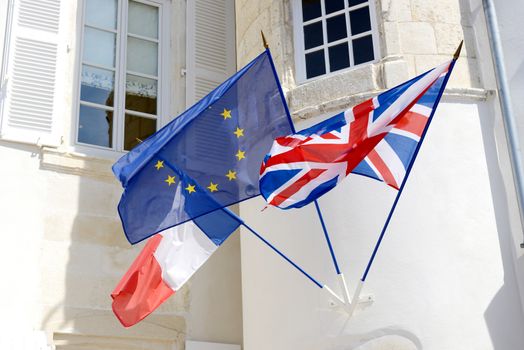 three flags fly together unity of france and england throught the  european union