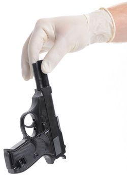 Concept of a crime scene with Forensic police picking up a gun isolated on white