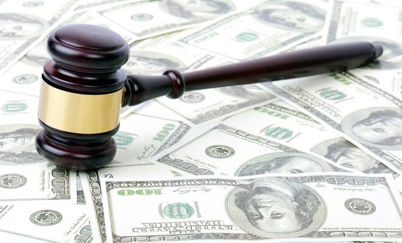 gavel on a background of hundred dollar bills concept of auction or law
