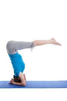 Yoga - young beautiful woman  yoga instructor  doing Lowered Bound Headstand (Salamba sirsasana with Urdhva Dandasana) exercise
 isolated on white background