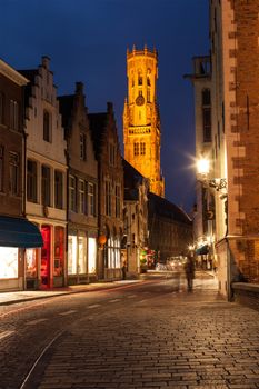 Bruges street in night. Belfry in background. Bruges, Belgium