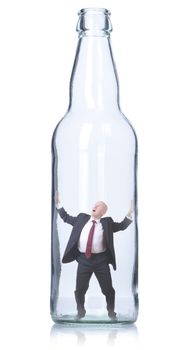 businessman trapped in a clear glass bottle isolated on white