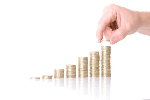 hand placing more money to growth chart of coins isolated on white background