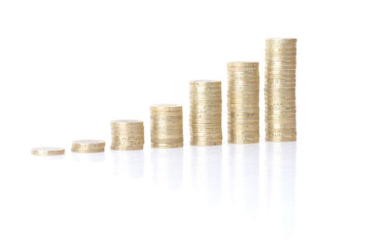 growing stacks of coins isolated on white background