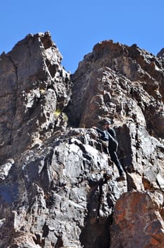 Young man climbing mountains