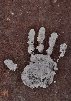 White handprint on rusty surface
