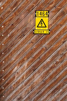 Background picture of a wood wall with danger electricity symbol