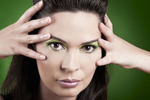 Portrait of a beautiful fashion woman over a green background