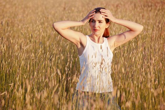 Outdoor portrait of a woman on a meadow releaxing