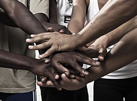 Closeup portrait of group with mixed race people with hands together