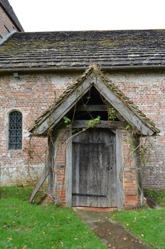 St Peters church in the tiny hamlet of Twineham,Sussex,England with its wooden door and rustic entrance.Built around 1695 by the Quacker's.