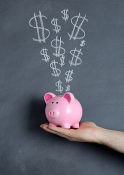 Piggy bank savings over chalkboard background