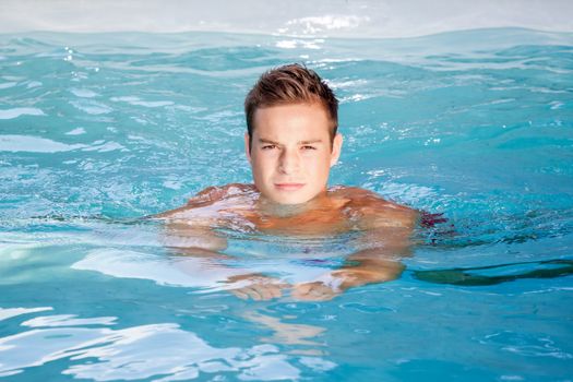 An image of a nice man swimming in the pool