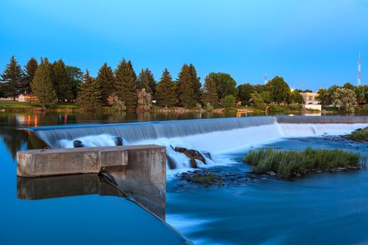 Wide waterfall on Snake River, in Idaho Falls, Idaho.  Near dusk of Summer time. Part of Power HydroElectric project of the city.