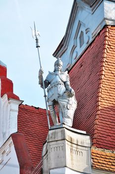 ancient hungarian soldier statue on a building roof
