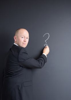 concept the question and answer session businessman in front of chalk board