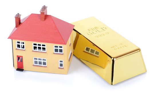 gold bar and house concept of real estate investment