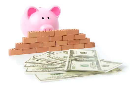 Concept of money blocked fron bank, savings with a piggy bank behind a brick wall unable to get to money.