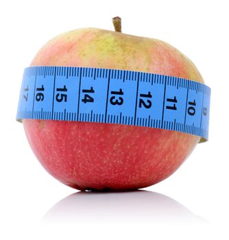 concept for healthy eating and dieting an apple with a tape measure isolated on a white bakground