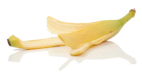 an eaten banana with peel left on a isolated white background