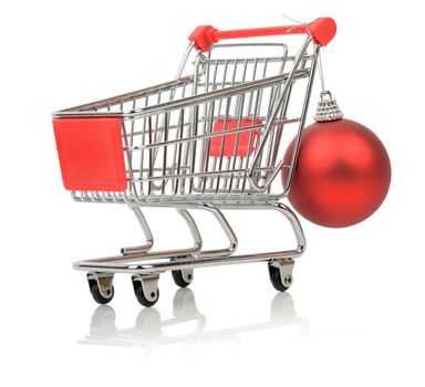 a shopping cart with a christmas bauble isolated on a white background