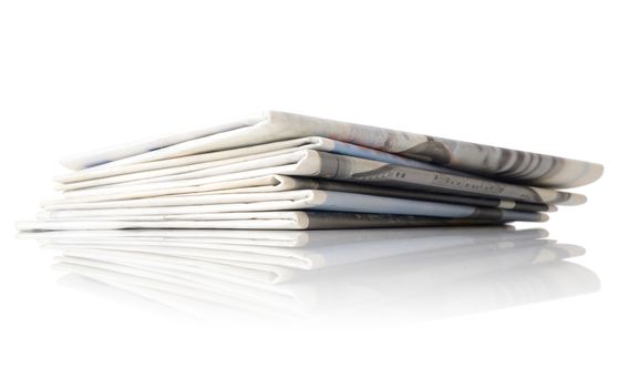 low angle shot of a pile on news papers isolated on a white background