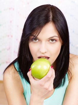 Pretty woman eating green apple