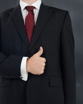 man in suit giving the thumbs up sign of a good job and everthing is alright