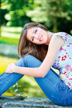 Cute brunette woman on sunny day in park, outdoor