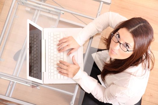 Cheerful business woman working on a Laptop.