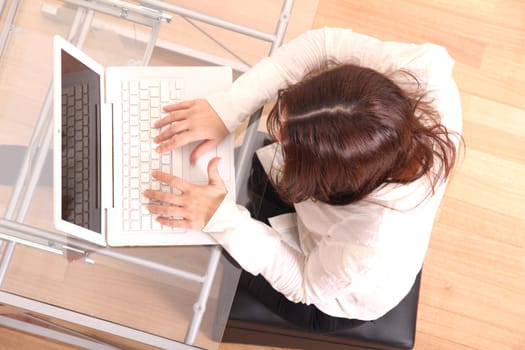 Cheerful business woman working on a Laptop.