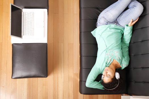 A jung brazilian woman relaxing on the sofa.