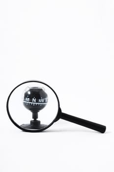 Orientation Concept Magnify Glass and Compass on a White Background