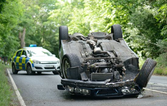 Car accident crash flipped upside down, road closed by police