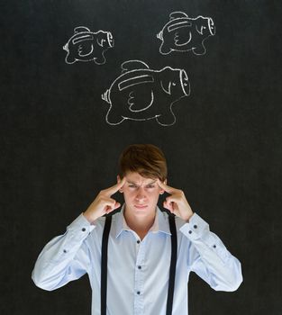 Thinking businessman with flying money piggy banks in chalk on blackboard background