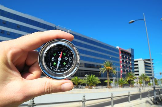 Orientation Concept a Male Hand Holding a Metal Compass in a City