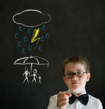 Thinking boy dressed up as business man thinking about protecting family from natural disaster on blackboard background