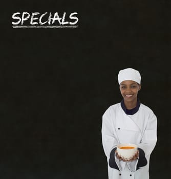 African American woman chef with chalk specials sign on blackboard background