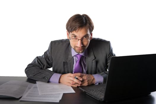 business man at his desk with a laptop on a white background isolated