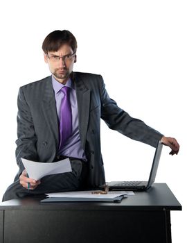 business man sitting on a desk with a laptop