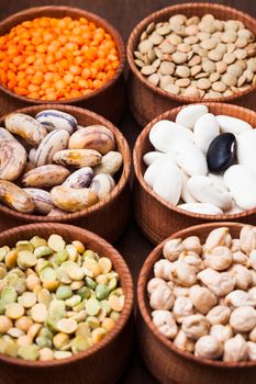 Different types of beans in wooden bowls