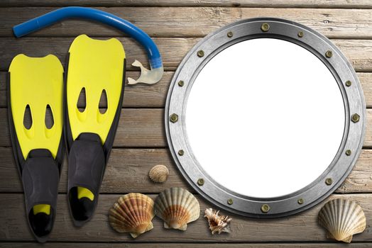 Metal empty porthole with seashells, yellow and black flippers and blue snorkel diving on wooden floor with sand