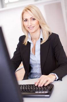 Beautiful businesswoman working on computer in the office